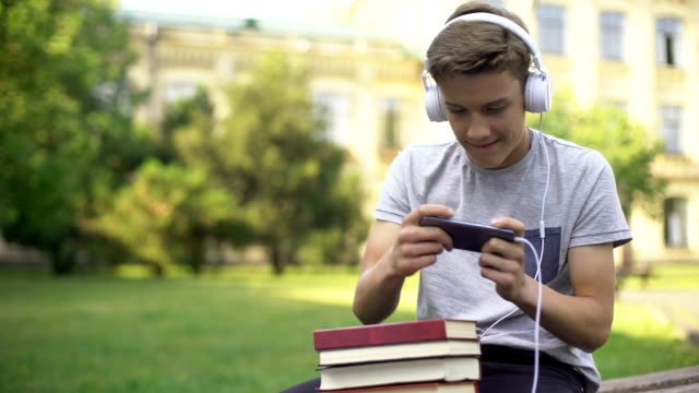 teen playing on phone